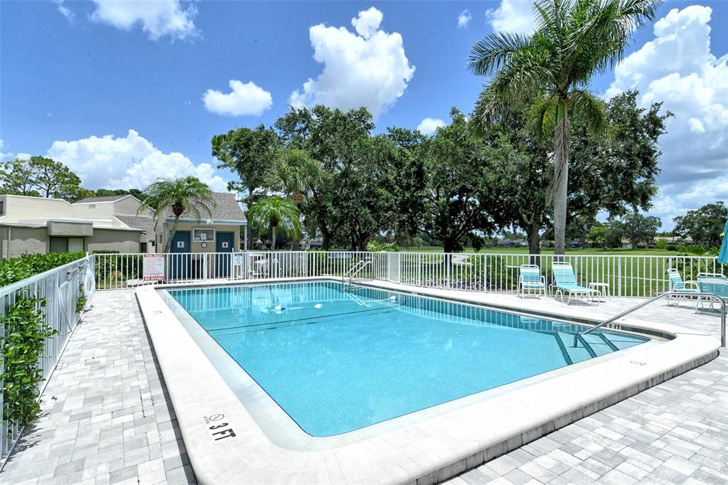 2517 Glebe Farm Close, Unit H2 Sarasota, FL 34235 - Photo 38 of 59 a view of a swimming pool with a patio