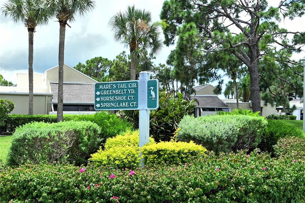 2517 Glebe Farm Close, Unit H2 Sarasota, FL 34235 - Photo 39 of 59 a garden covered with tall trees
