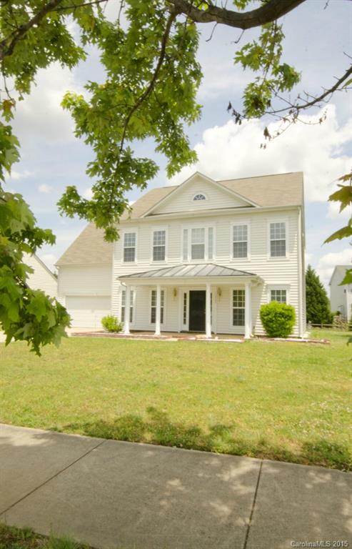 12809 Winget Road Charlotte, NC 28278 - Photo 2 of 23 a front view of a house with a garden and tree