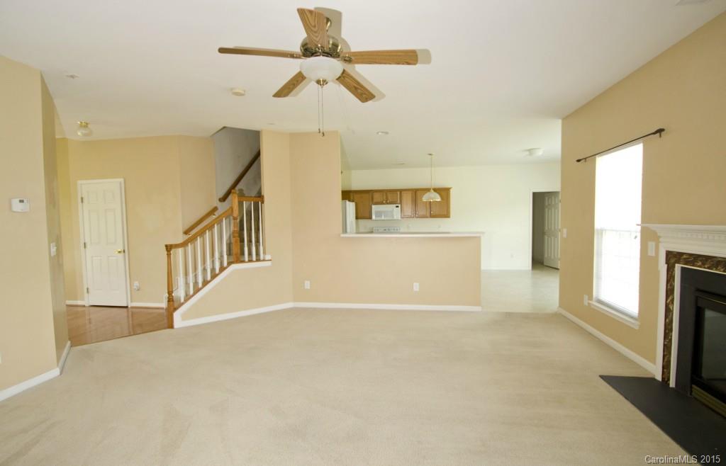 12809 Winget Road Charlotte, NC 28278 - Photo 11 of 23 a view of an empty room with a fireplace and a window