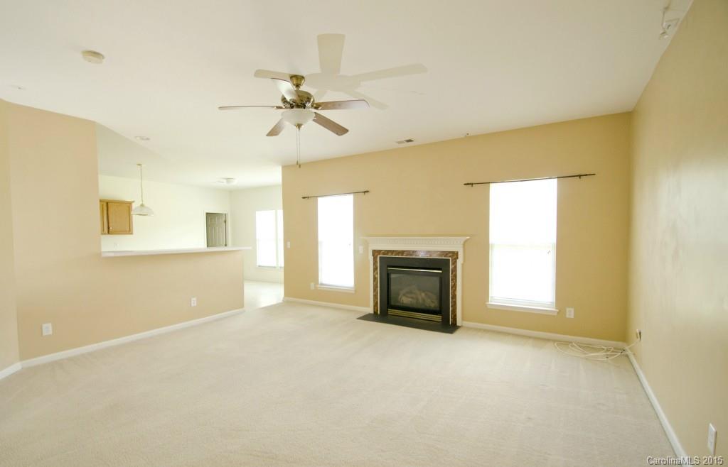 12809 Winget Road Charlotte, NC 28278 - Photo 12 of 23 a view of empty room with a fireplace and a window