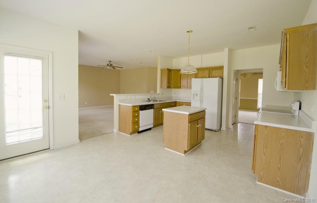 12809 Winget Road Charlotte, NC 28278 - Photo 13 of 23 a view of a kitchen with a sink cabinets and a refrigerator