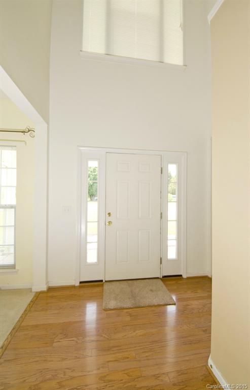 12809 Winget Road Charlotte, NC 28278 - Photo 5 of 23 an empty room with wooden floor and windows
