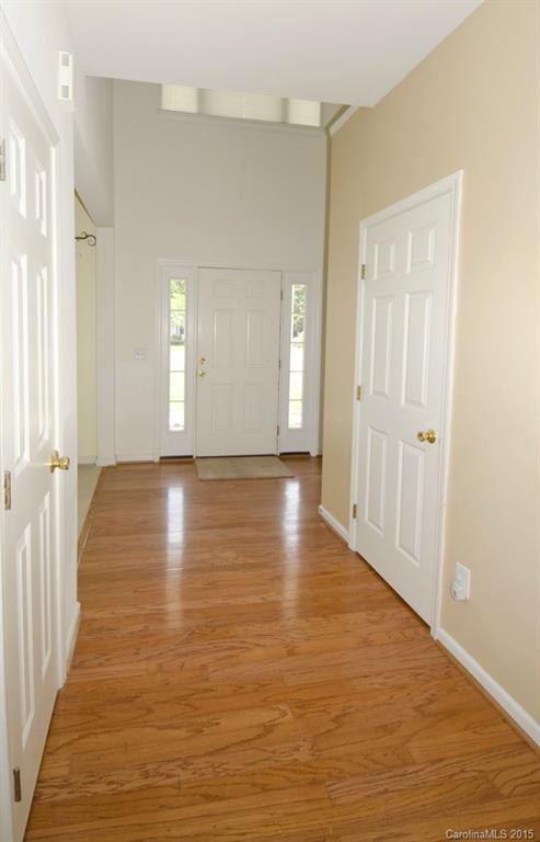 12809 Winget Road Charlotte, NC 28278 - Photo 7 of 23 a view of a hallway with wooden floor and staircase