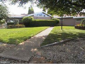 1 Club House Road Brick, NJ 08723 - Photo 2 of 6 a front view of a house with garden