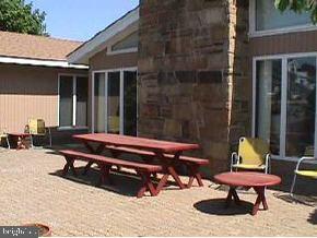 1 Club House Road Brick, NJ 08723 - Photo 6 of 6 a wooden bench sitting in front of a building