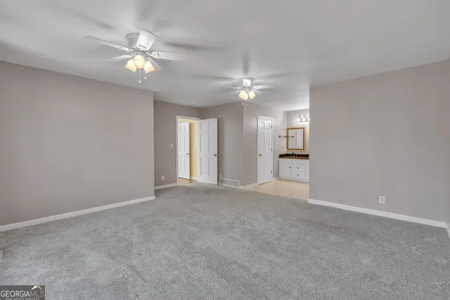 a view of a hallway with wooden floor and door