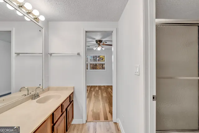 a view of an empty room with a fireplace and a window