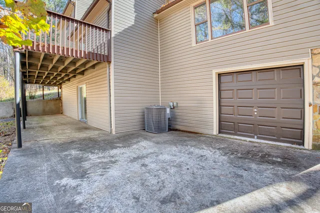 a backyard of a house with table and chairs