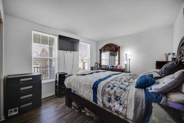 a bedroom with a bed and a dresser