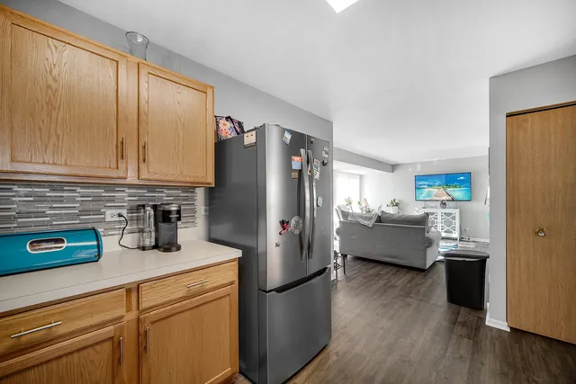 a kitchen with stainless steel appliances a refrigerator a sink a stove and cabinets
