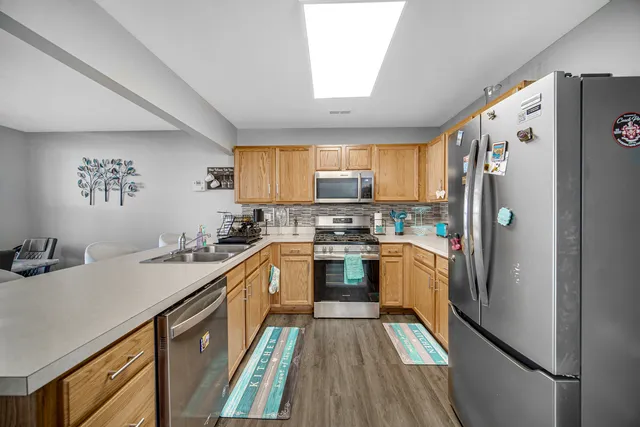 a kitchen with granite countertop a refrigerator stove and sink