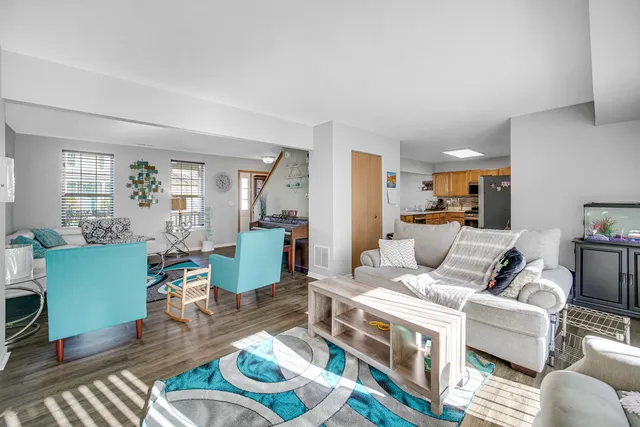 a living room with furniture wooden floor and a table
