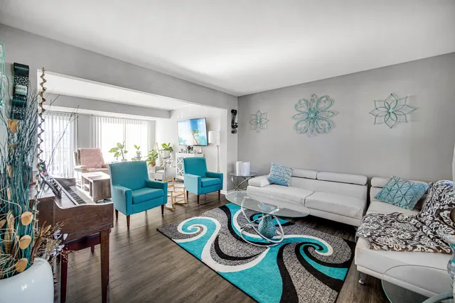 a living room with furniture and wooden floor