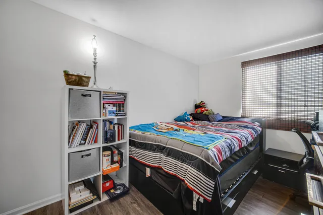 a bedroom with a bed and a book shelf