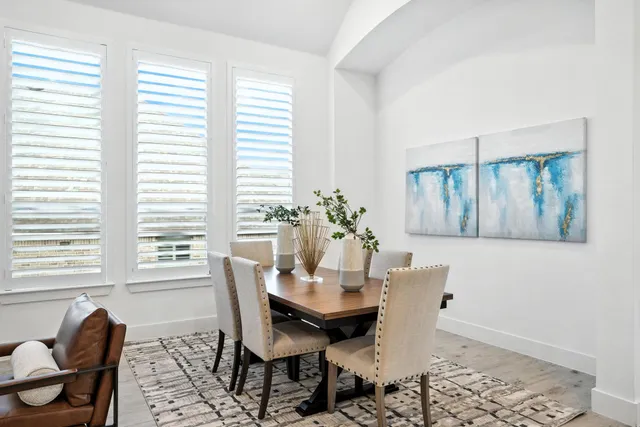 a view of an empty room with wooden floor and closet
