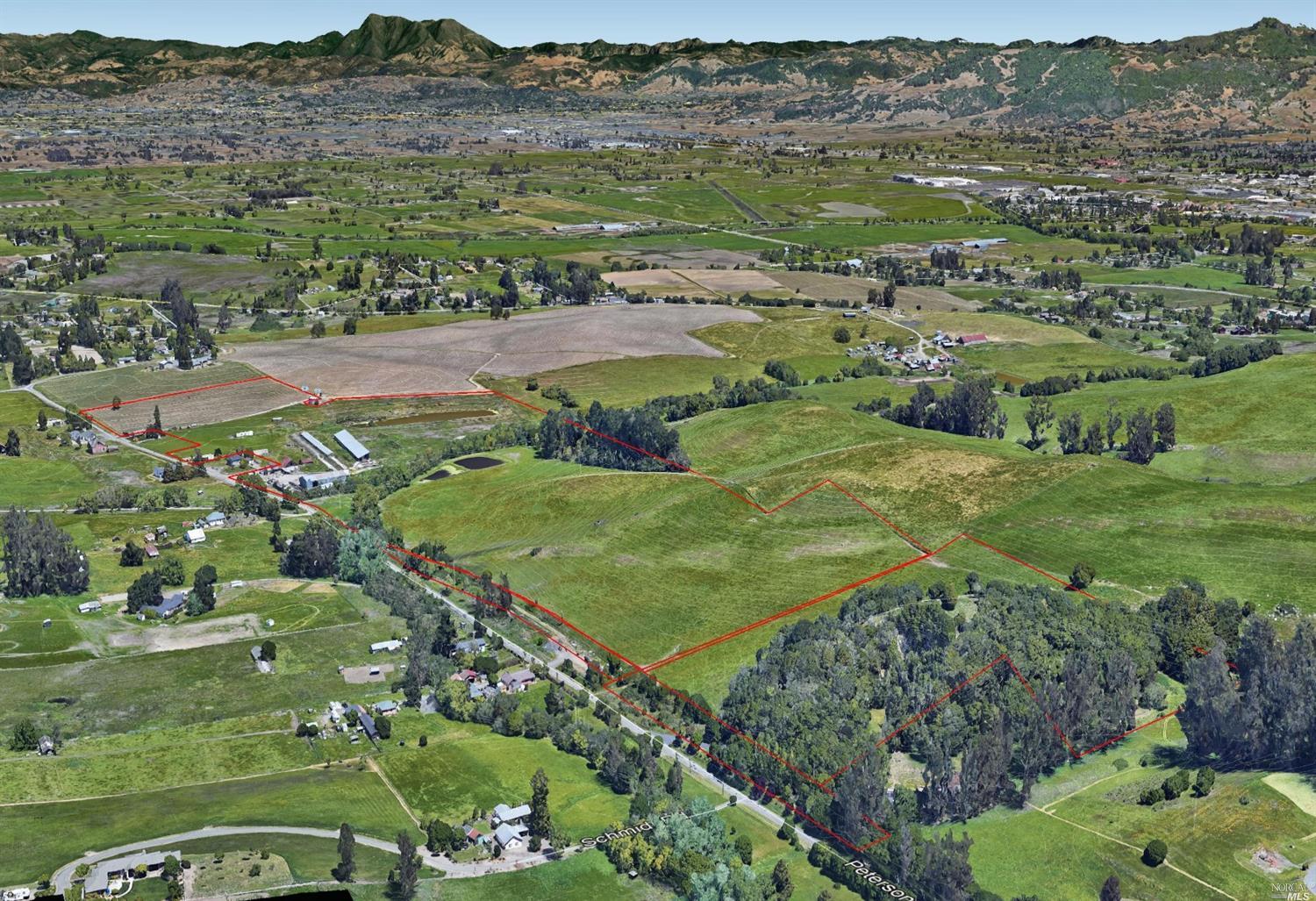 a view of a lush green hillside and houses