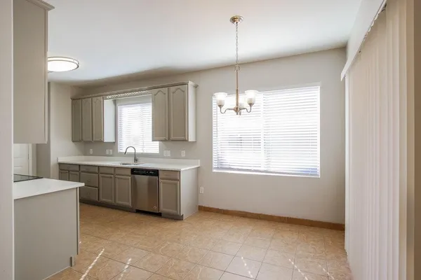 a large kitchen with kitchen island white cabinets and window