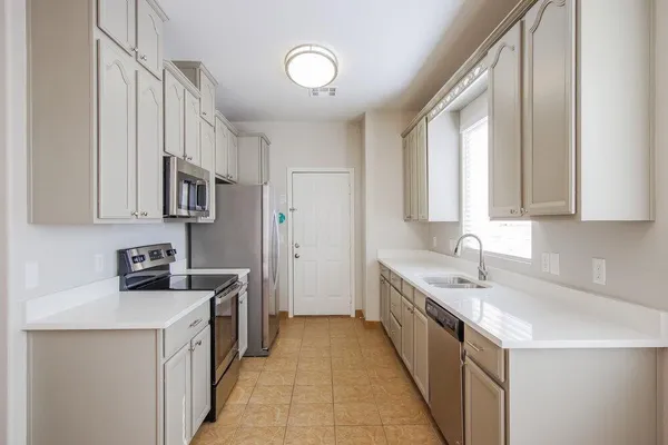 a kitchen with a sink stove and cabinets