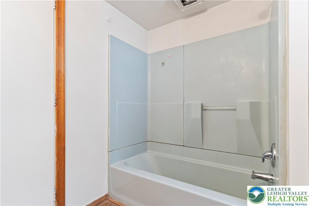 624 Cleveland Street Allentown, PA 18103 - Photo 18 of 35 a white bath tub sitting next to a white cabinet