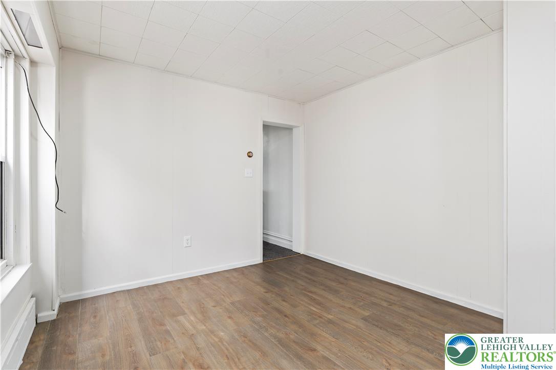 624 Cleveland Street Allentown, PA 18103 - Photo 8 of 35 a view of an empty room with wooden floor and a window