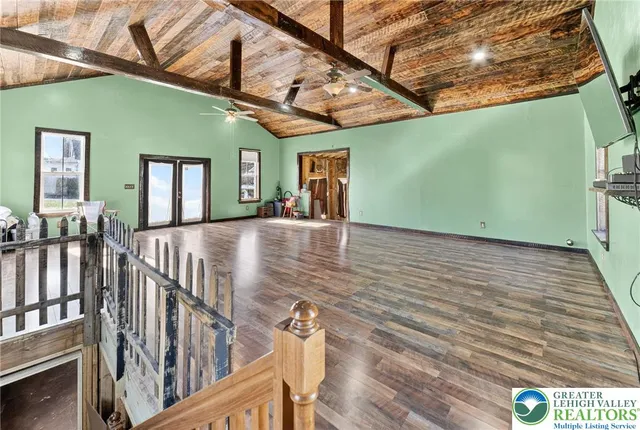 a view of a room with wooden floor and stairs