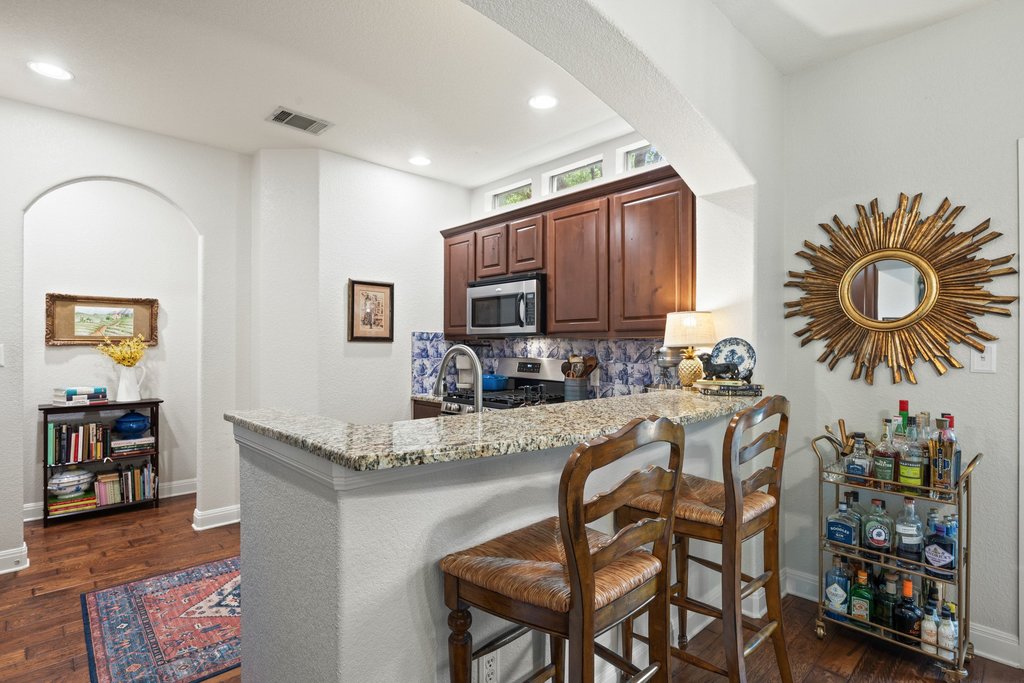 6708 Menchaca Road, Unit 2 Austin, TX 78745 - Photo 9 of 30 Kitchen breakfast bar with a granite countertop and integrated sink