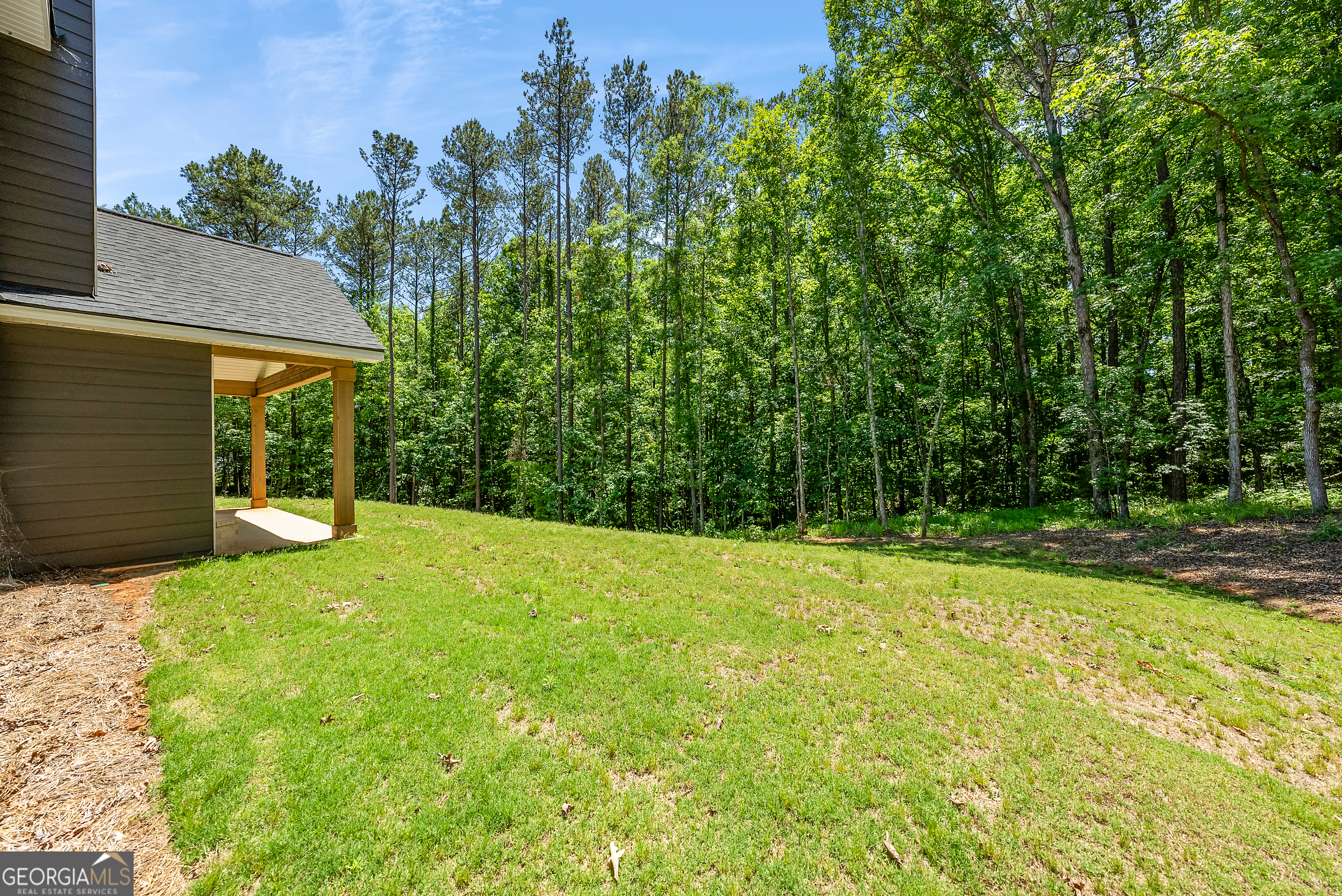 38 Oak Ridge Drive, Unit 26 Waverly Hall, GA 31831 - Photo 36 of 37 a view of a backyard with a garden