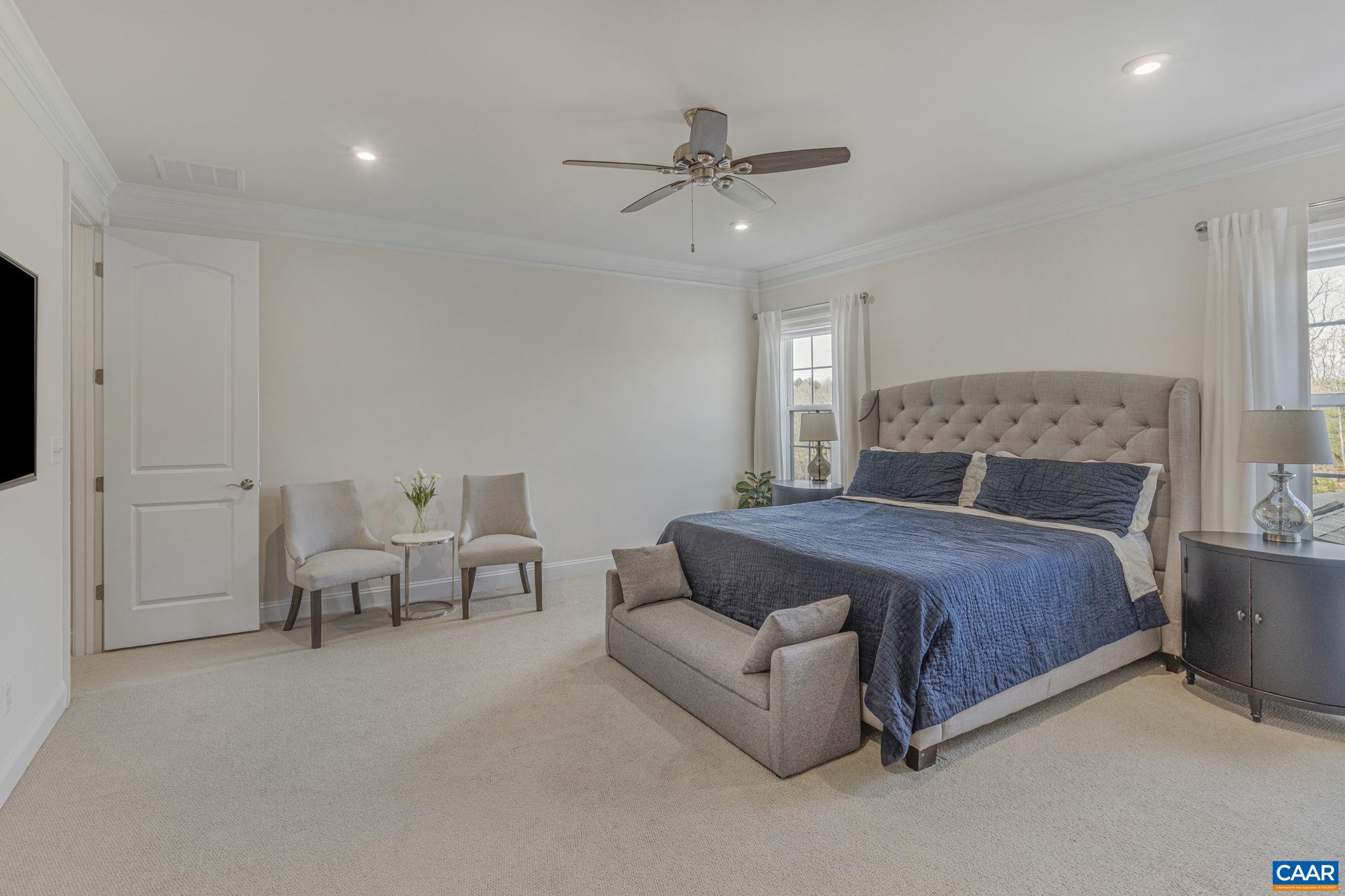 3624 Osprey Drive Keswick, VA 22947 - Photo 36 of 68 a bedroom with furniture and a chandelier