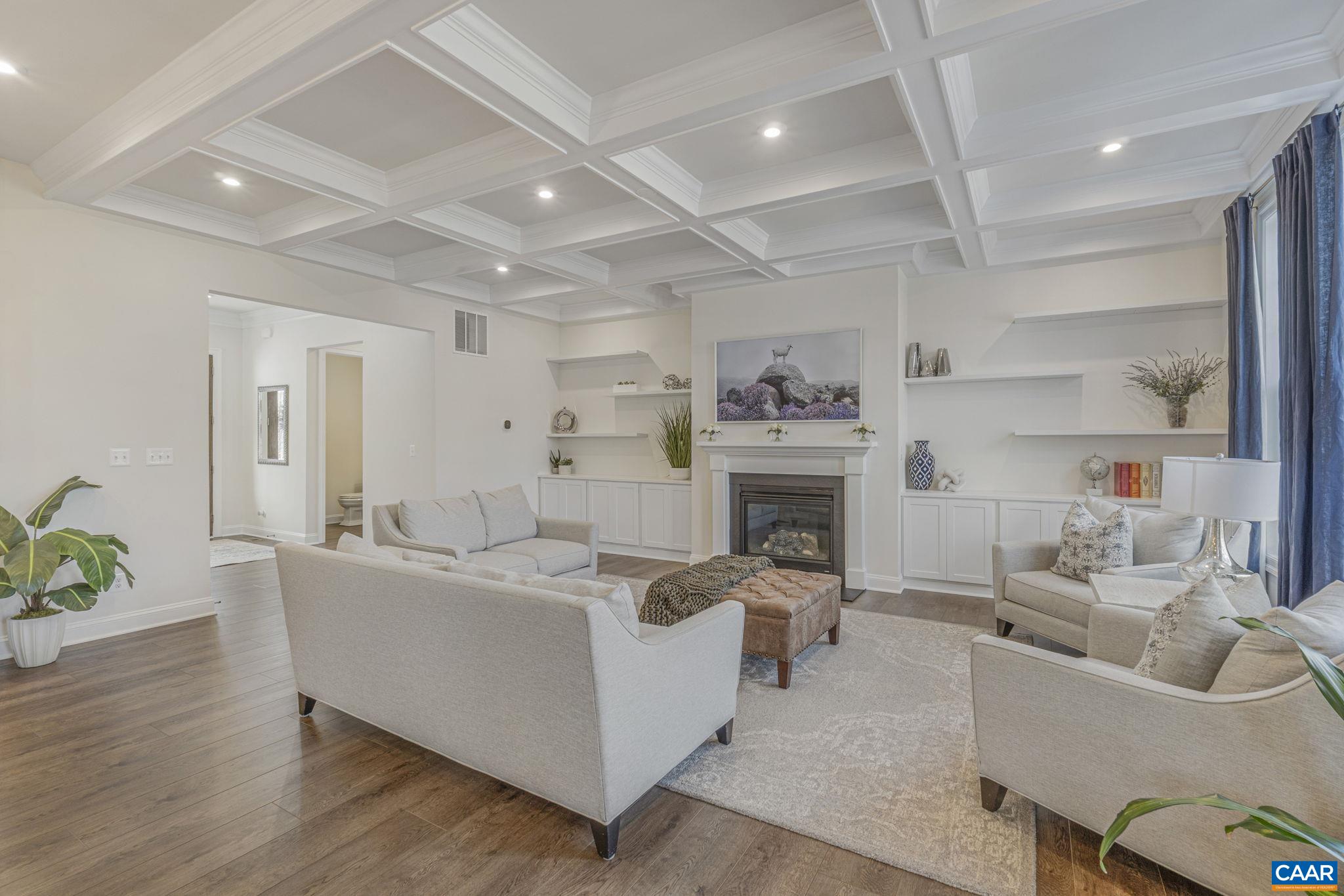 3624 Osprey Drive Keswick, VA 22947 - Photo 5 of 68 a living room with furniture a fireplace and a chandelier