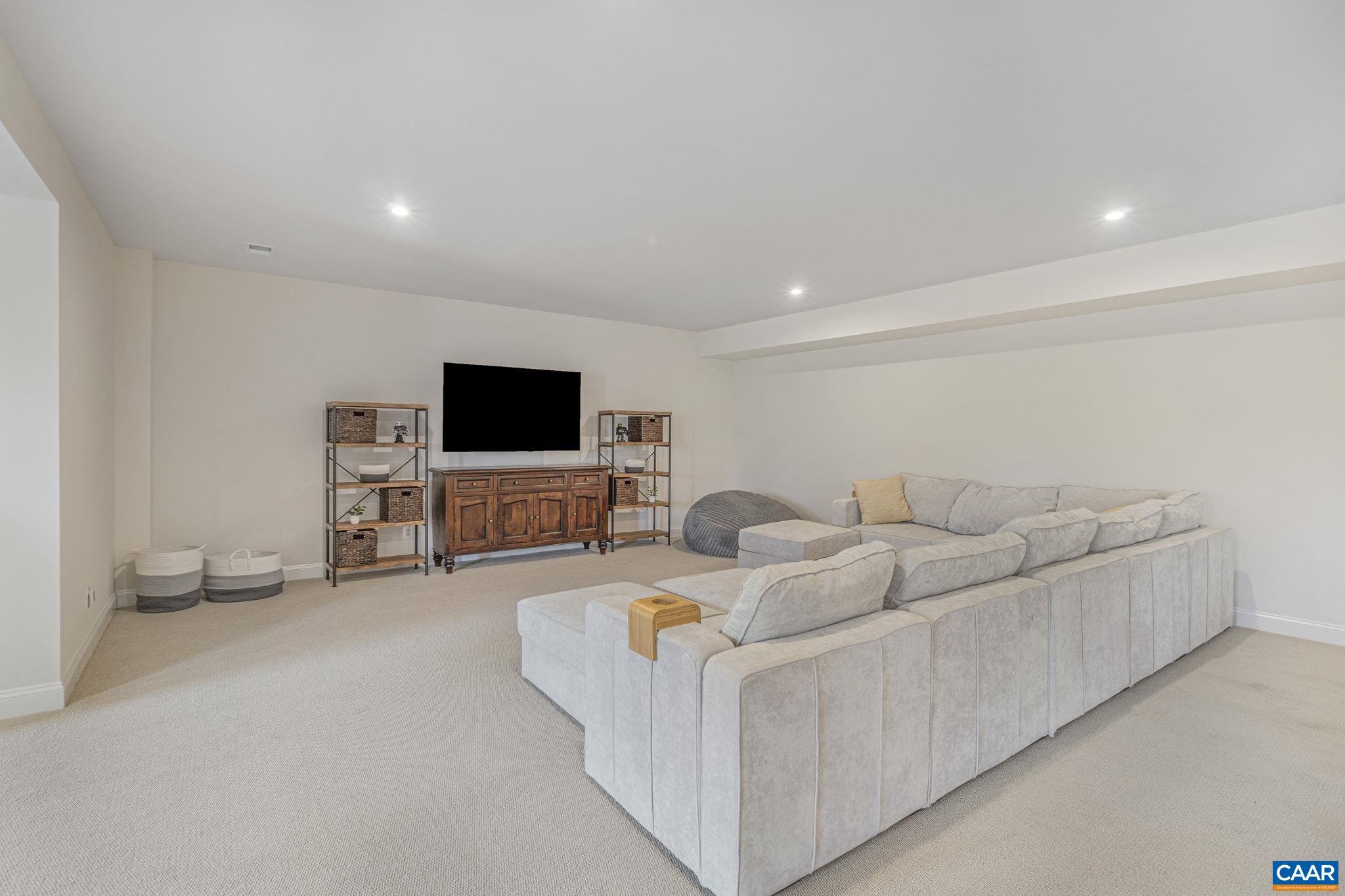 3624 Osprey Drive Keswick, VA 22947 - Photo 54 of 68 a living room with furniture and a flat screen tv