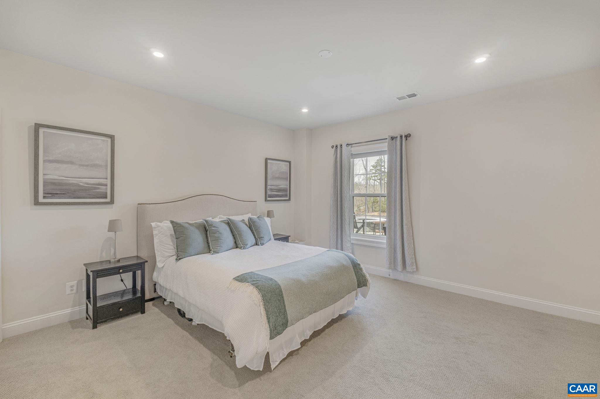 3624 Osprey Drive Keswick, VA 22947 - Photo 57 of 68 a spacious bedroom with a bed and a night stand