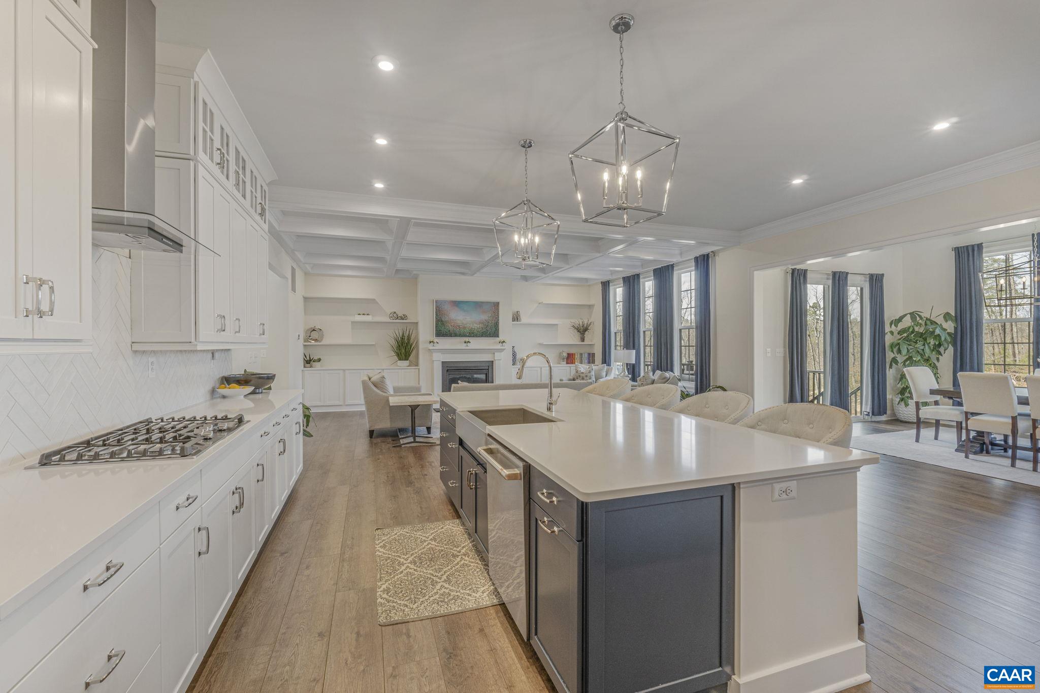 3624 Osprey Drive Keswick, VA 22947 - Photo 8 of 68 a large kitchen with granite countertop a sink dishwasher a stove and white cabinets with wooden floor