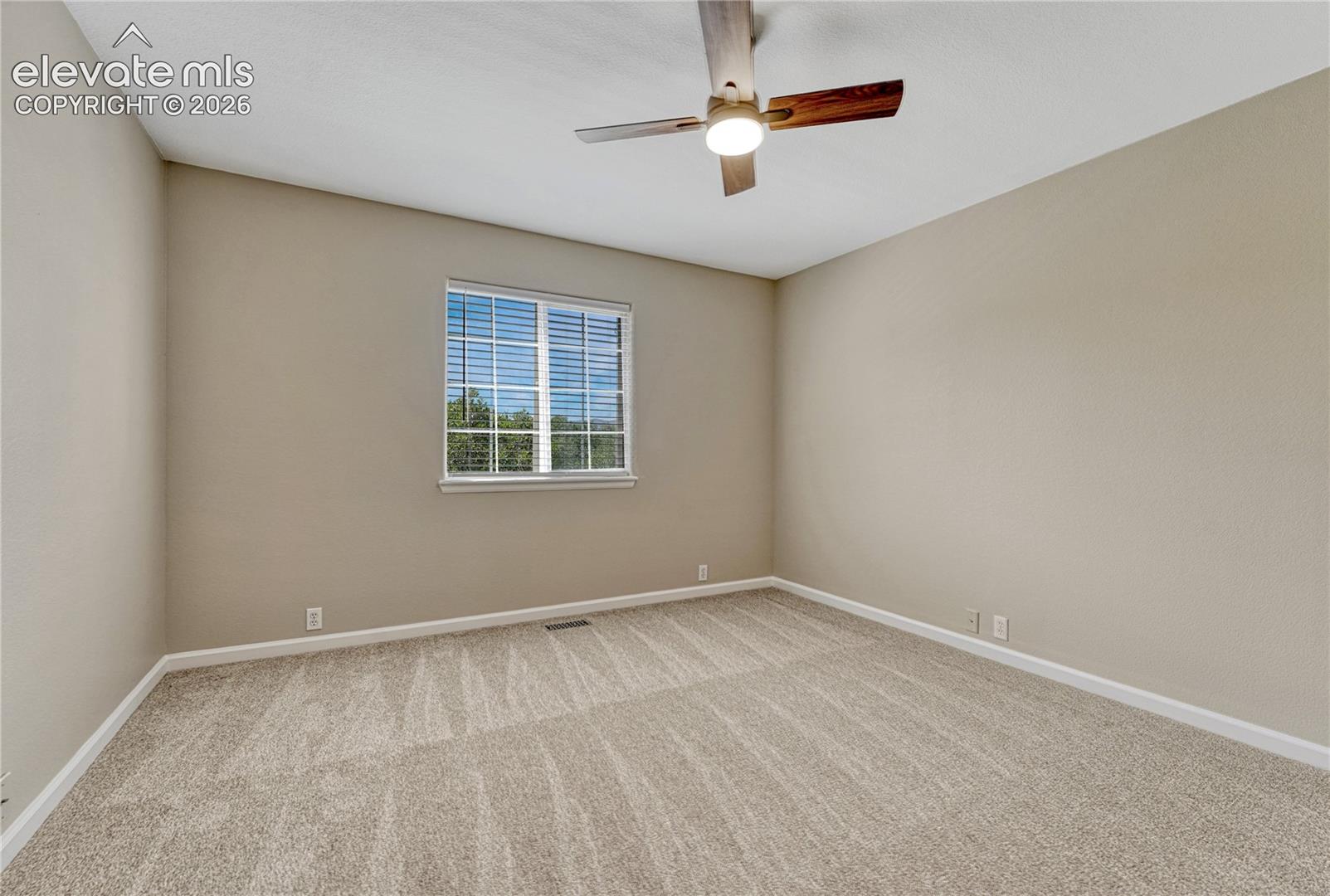 4147 Diamond Ridge View Colorado Springs, CO 80918 - Photo 26 of 42 A large window drenches the second upper bedroom in abundant natural light, framing peaceful views of the surrounding community