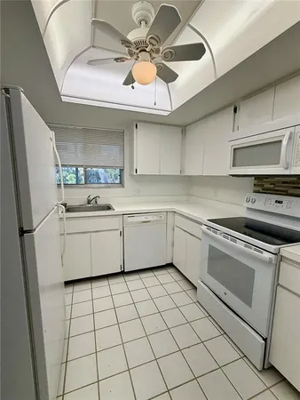 an empty room with windows and door