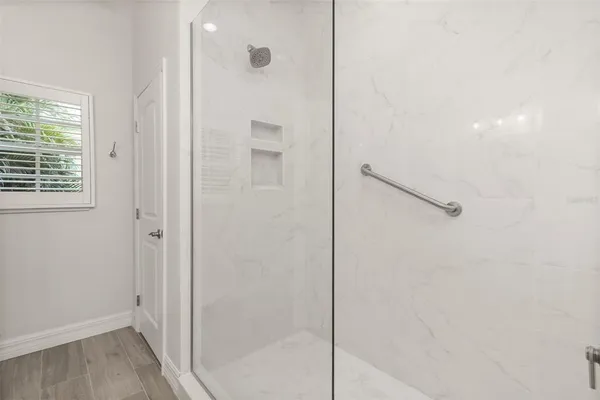 wooden floor in an empty room with a window