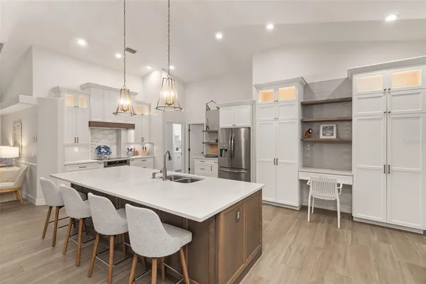 a large kitchen with a table and chairs