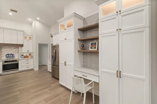 a kitchen with stainless steel appliances a refrigerator and cabinets