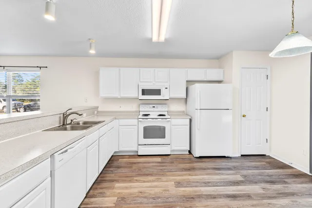 a kitchen with a white cabinets and white appliances