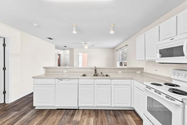 a kitchen with a sink stove and cabinets