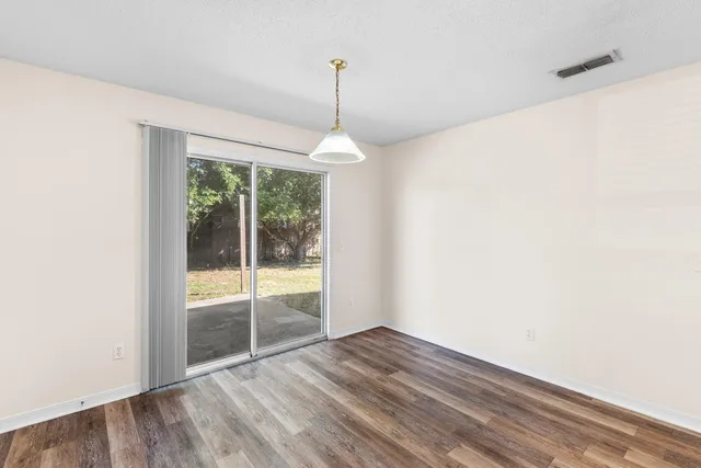 a view of a room window and wooden floor