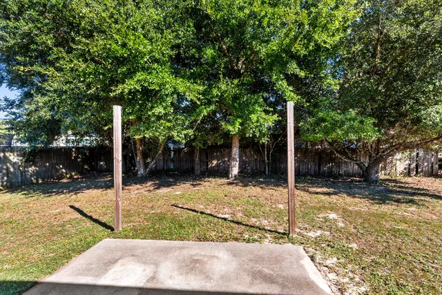 a view of a patio with a table chairs and a fire pit
