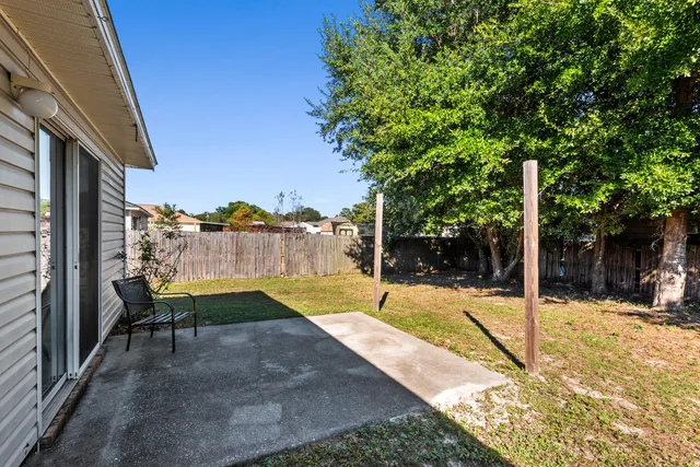 a view of a backyard with swimming pool