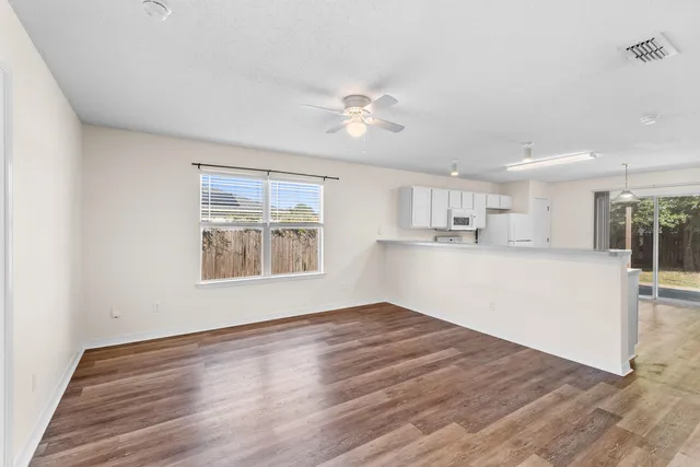 a view of kitchen with wooden floor and window