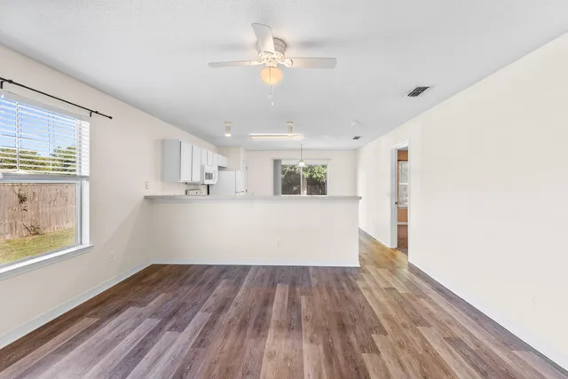 a view of kitchen and hall with wooden floor