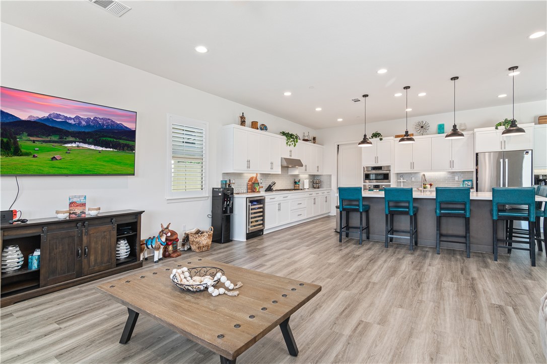 11523 Explorer Court Corona, CA 92883 - Photo 13 of 64 a living room with lots of furniture and kitchen view