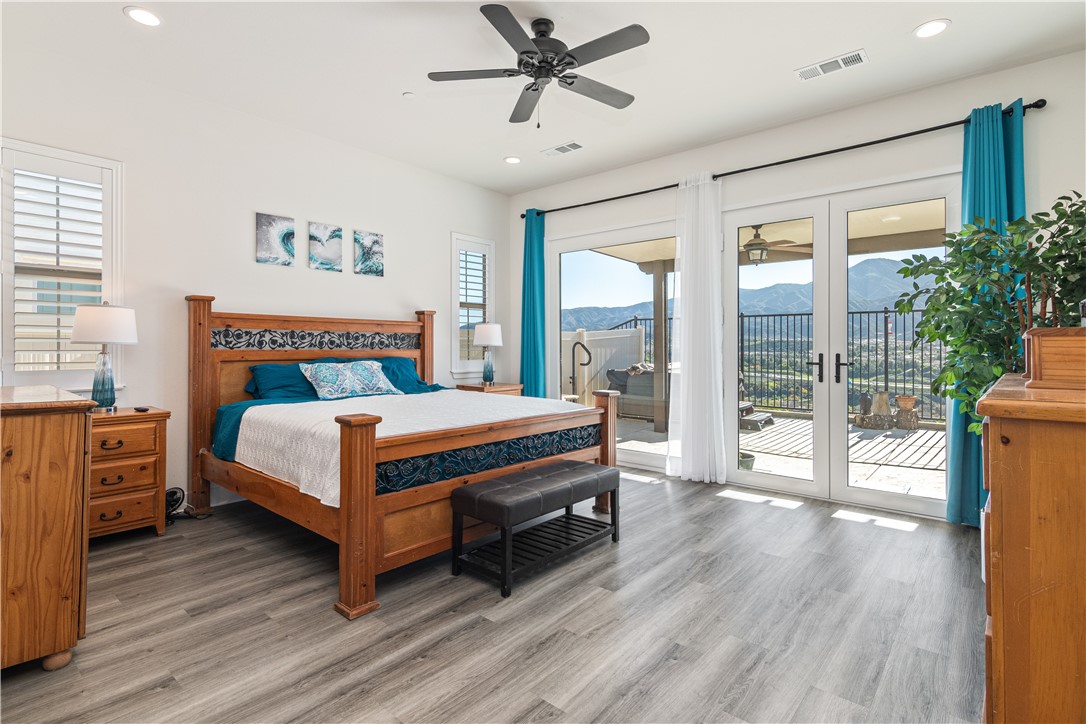 11523 Explorer Court Corona, CA 92883 - Photo 14 of 64 a bedroom with a bed and wooden floor