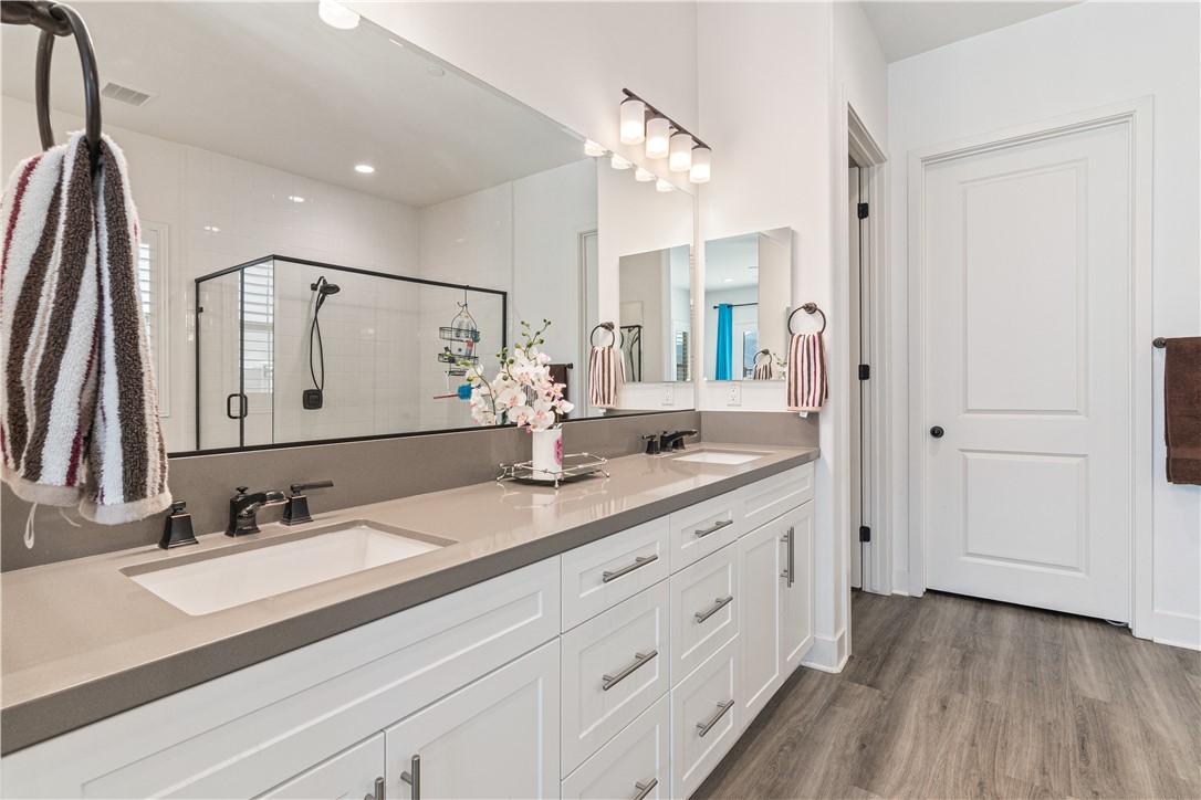 11523 Explorer Court Corona, CA 92883 - Photo 16 of 64 a bathroom with a double vanity sink and a mirror