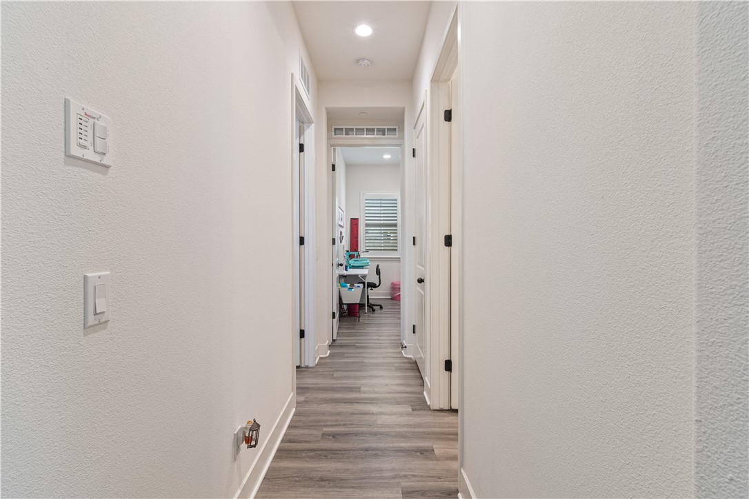 11523 Explorer Court Corona, CA 92883 - Photo 20 of 64 a view of a hallway with wooden floor and staircase