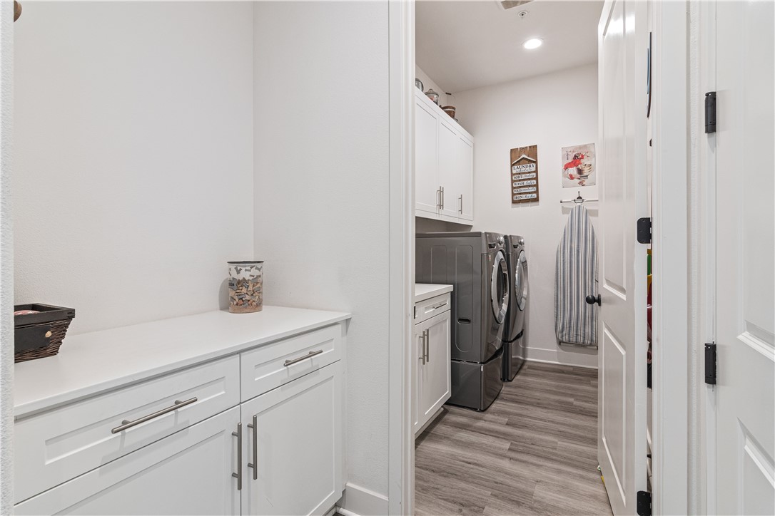 11523 Explorer Court Corona, CA 92883 - Photo 30 of 64 a hallway with cabinets and wooden floor